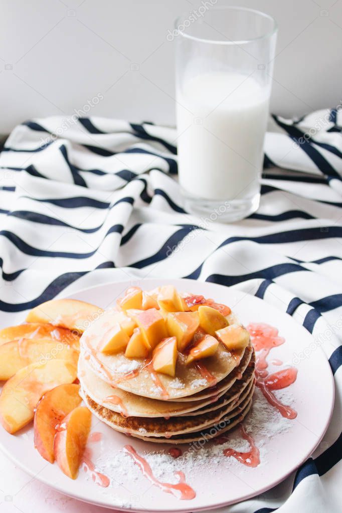 stack of delicious homemade pancakes with sauce and sliced apple 