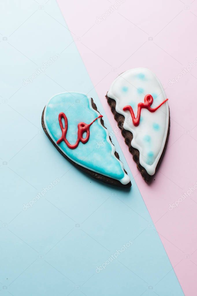 two cookies in shape of broken heart with glaze