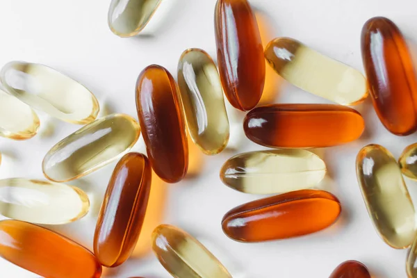 pile of scattered capsules with medication on white background