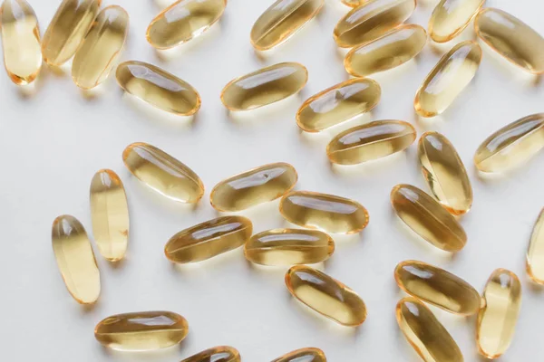 pile of scattered capsules with medication on white background