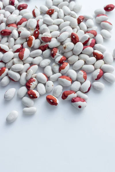 scattered raw beans on white background