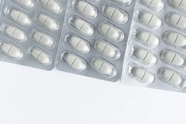 blisters with pills on white background