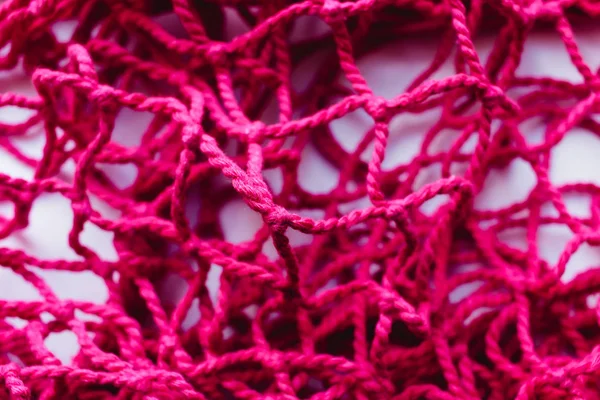 stock image pink string bag background, net pattern