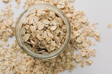 beyaz arka plan üzerinde ham yulaf gevreği ile kavanoz