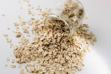 beyaz arka plan üzerinde ham yulaf gevreği ile kavanoz