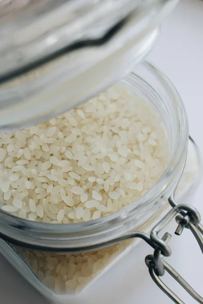 raw white rice in jar , macro