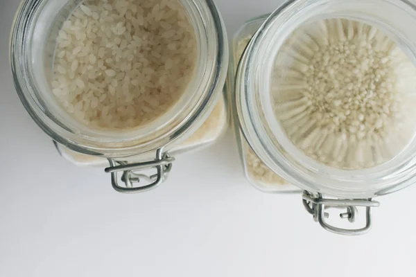 raw white rice in jars , macro