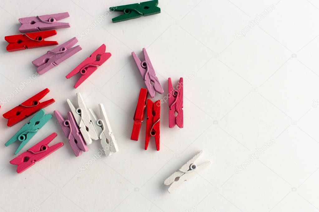 pile of scattered clothes pegs isolated on white background