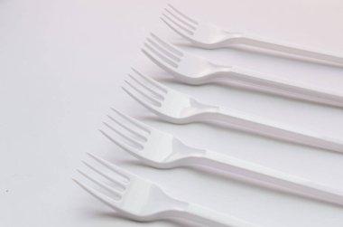 beyaz plastik çatal düz beyaz arka plan üzerinde yatıyordu