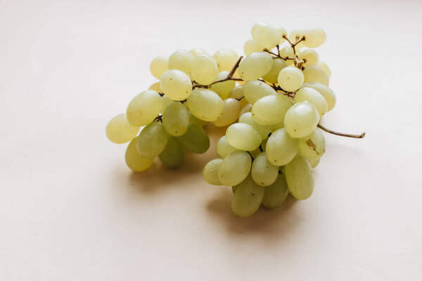 pile of fresh green grapes on white background