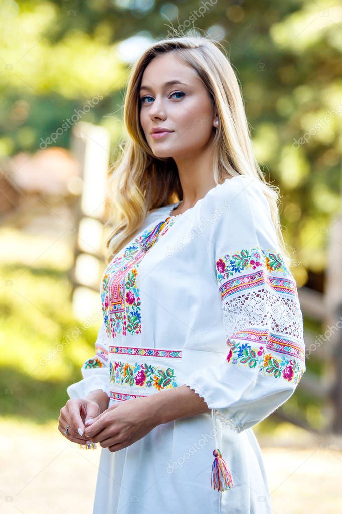 Beautiful blonde Ukrainian girl with blue eyes  in folk clothing. Boho style in fashion. Traditional and nature  style. National look