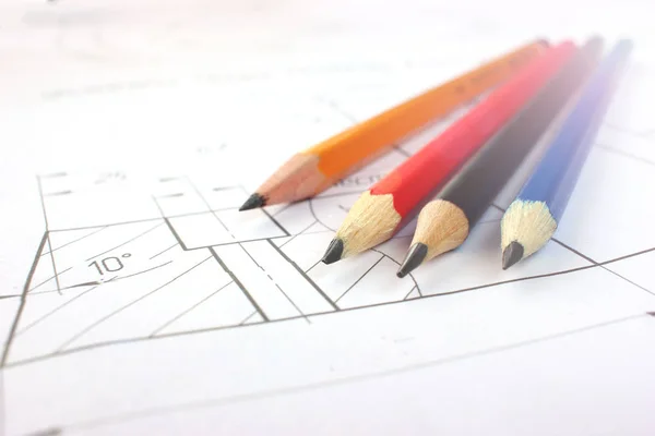 Open drawings with a pencil. Engineering and design. Construction projects. Planning.