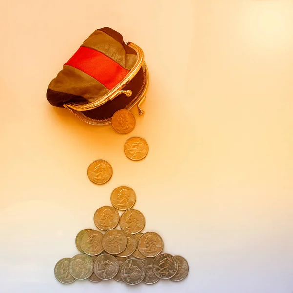 American dollars in a coin purse on a white background. Close-up. The concept of saving money in crisis and home finance, savings.