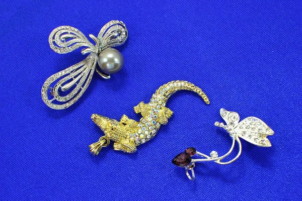 luxury jewelry with stones. Women\'s jewelry. Concept of luxury jewelry, blue background