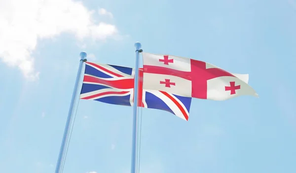 Reino Unido Georgia Dos Banderas Ondeando Contra Cielo Azul Imagen — Foto de Stock