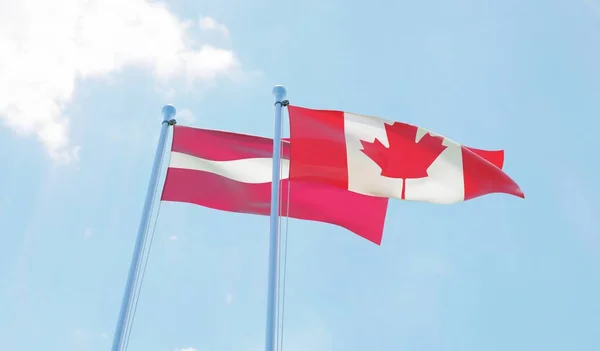 Letônia Canadá Duas Bandeiras Acenando Contra Céu Azul Imagem — Fotografia de Stock
