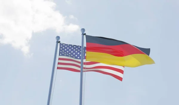 Alemania Dos Banderas Ondeando Contra Cielo Azul Imagen —  Fotos de Stock