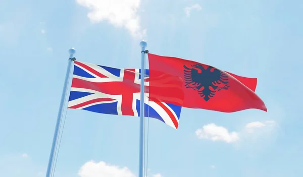 Albania Reino Unido Dos Banderas Ondeando Contra Cielo Azul Imagen —  Fotos de Stock
