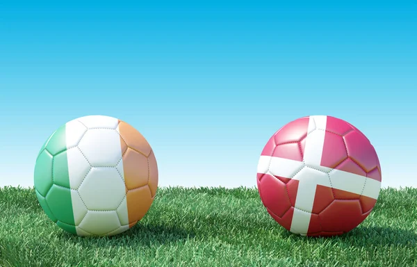 Two soccer balls in flags colors on green grass. Ireland and Denmark. EURO 2020. Group D. 3d image