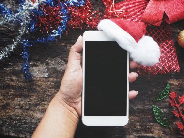 Yandan telefon Noel şapka ile akıllı