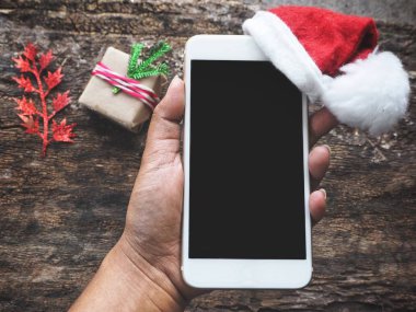 Yandan telefon Noel şapka ile akıllı