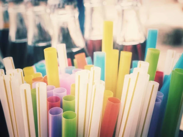 Colorful drinking straws and cola drink
