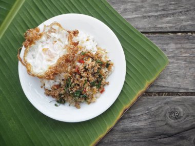 Fesleğen domuz eti ve kızarmış yumurta muz yaprakları üzerinde Tayland Gıda