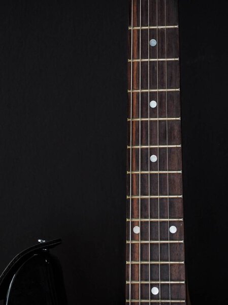 Close up of guitars on black background