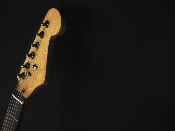 Close up of guitars on black background