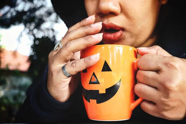 Cadılar Bayramı Bardağında Kahve Dinleyen Bir Kadın — Stok fotoğraf