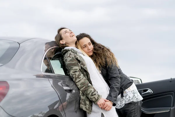 Two cheerful women together a vehicle