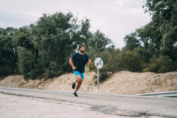 Classic vintage man does sport and runs in the field.