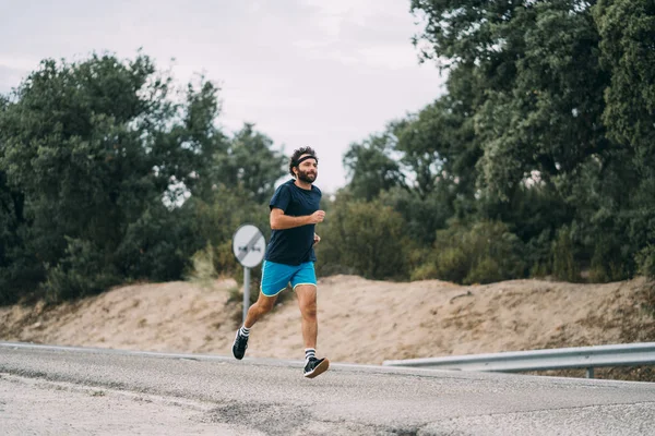 Classic vintage man does sport and runs in the field.