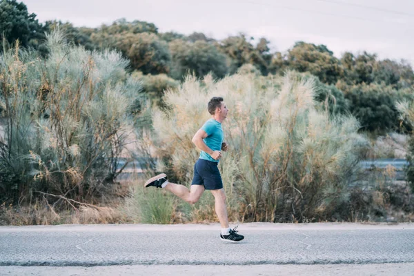 Classic vintage man does sport and runs in the field.