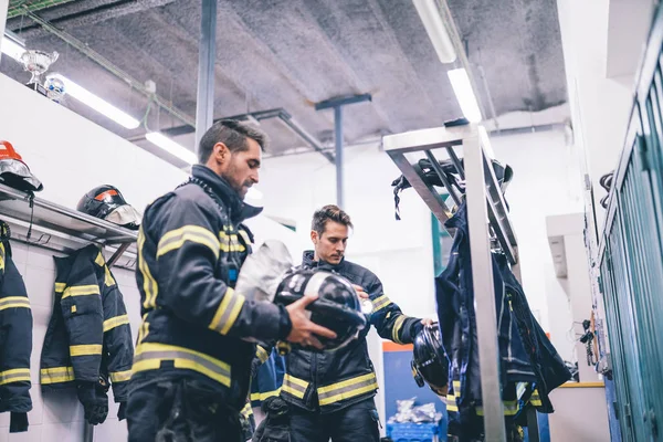 Firemen preparing for emergency service.