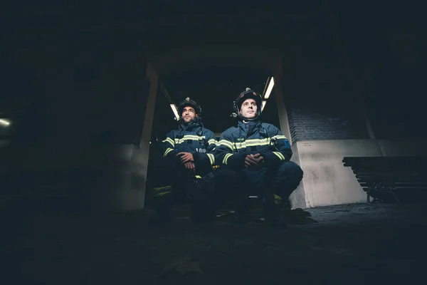Two male firefighter posing to camera.