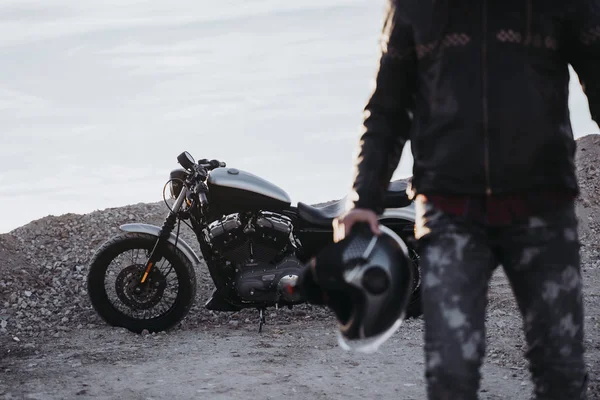 Man running to ride a motorcycle.