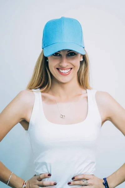 Pretty blond woman with blue baseball hat.