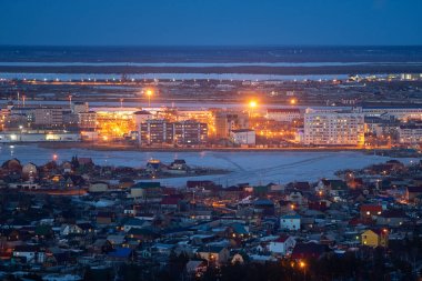 Aerial view of Yakutsk, Yakutia skyline with Beloe lake in beautiful post sunset twilight during blue hour at dusk with clear blue sky in cold spring  clipart