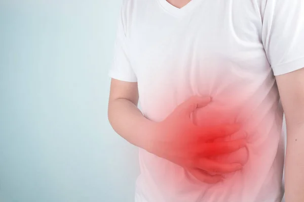 Asian Young men are suffering from stomach ulcers. gastritis Caused by the infection of H. pylori bacteria  healthcare and health problem concept