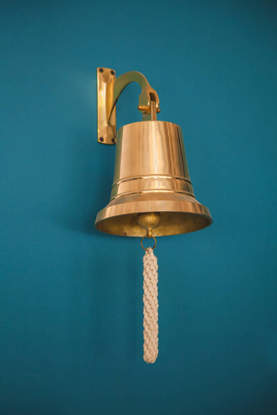 close-up of ship bell on a dark wall . background