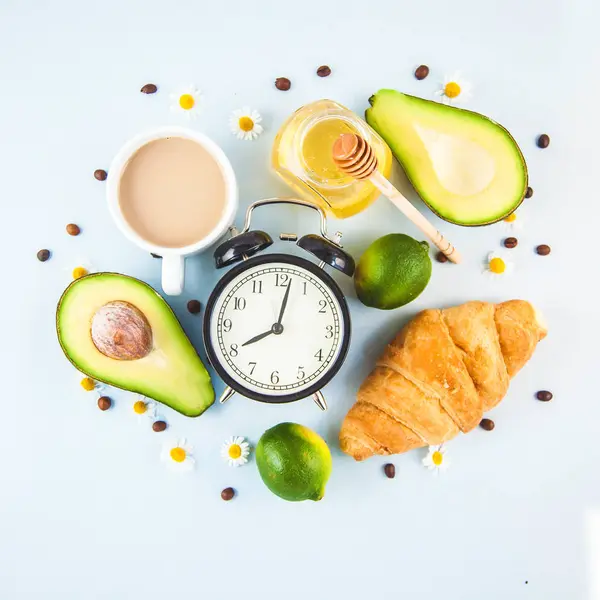 sabah kahvaltı, kahve Kupası'nda bir beyaz kruvasan avokado uyanış neşeli, sağlıklı bir çalar saat ile kahvaltı taze kopya alanı