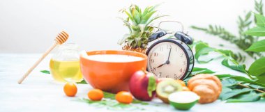 sabah kahvaltı, müsli, meyve, şeftali, bal ve ananas yeşil ışık bir zemin üzerine bırakır uyanış bir çalar saat ile sağlıklı kahvaltı tazelik boşaltmak afiş