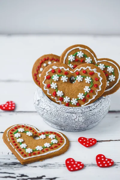 Gingerbread Cookies hearts in a cup on a white wooden background. Valentines day concept Copy space