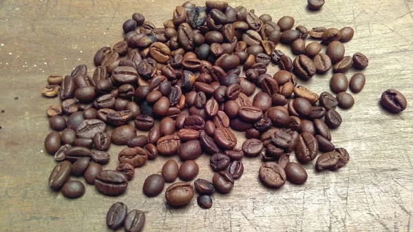 Koffiebonen Verspreid Een Houten Tafel — Stockfoto