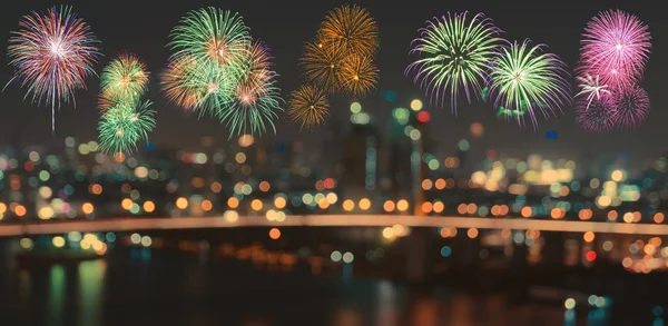 Colorful fireworks on blurred bokeh city night lights background Stock Picture