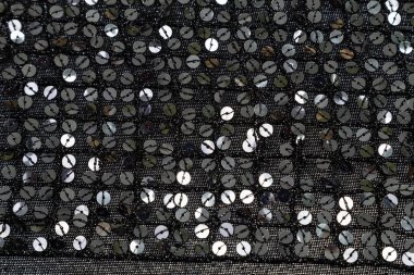 arka plan siyah parlak kumaş ile payetler kaplı