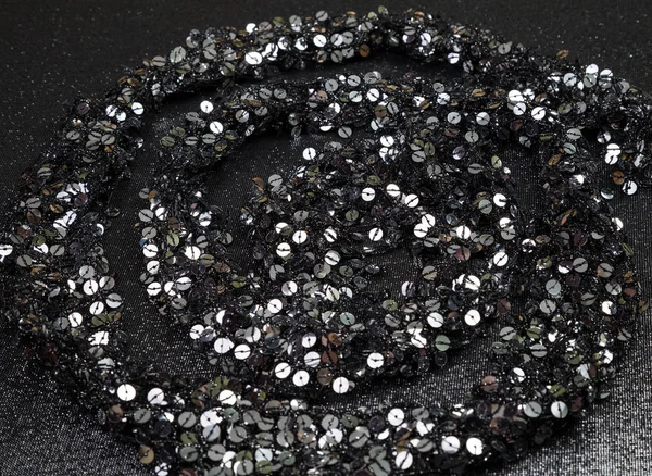 spiral lined sequins on black sequined fabric