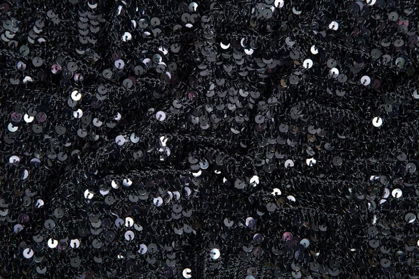 fabric with round black sequins on knitted basis