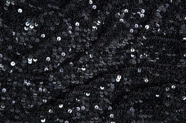 fabric with round black sequins on knitted basis